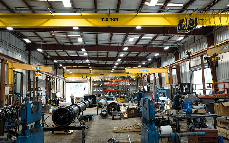 Interior view of the SKF-certified pump repair facility in Augusta, GA, featuring overhead cranes, workstations, and pump repair equipment.