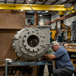 Expert technicians performing a vertical cantilever pump repair, enhancing the efficiency of industrial pump systems at Southeast Pump Specialist.