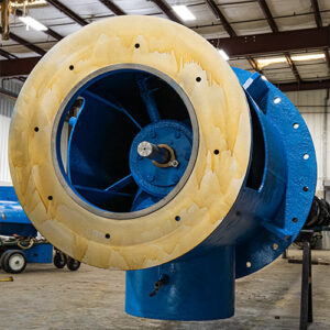 Close-up of a vertical turbine pump head, a key component in industrial pump systems, under maintenance and repair for improved performance.